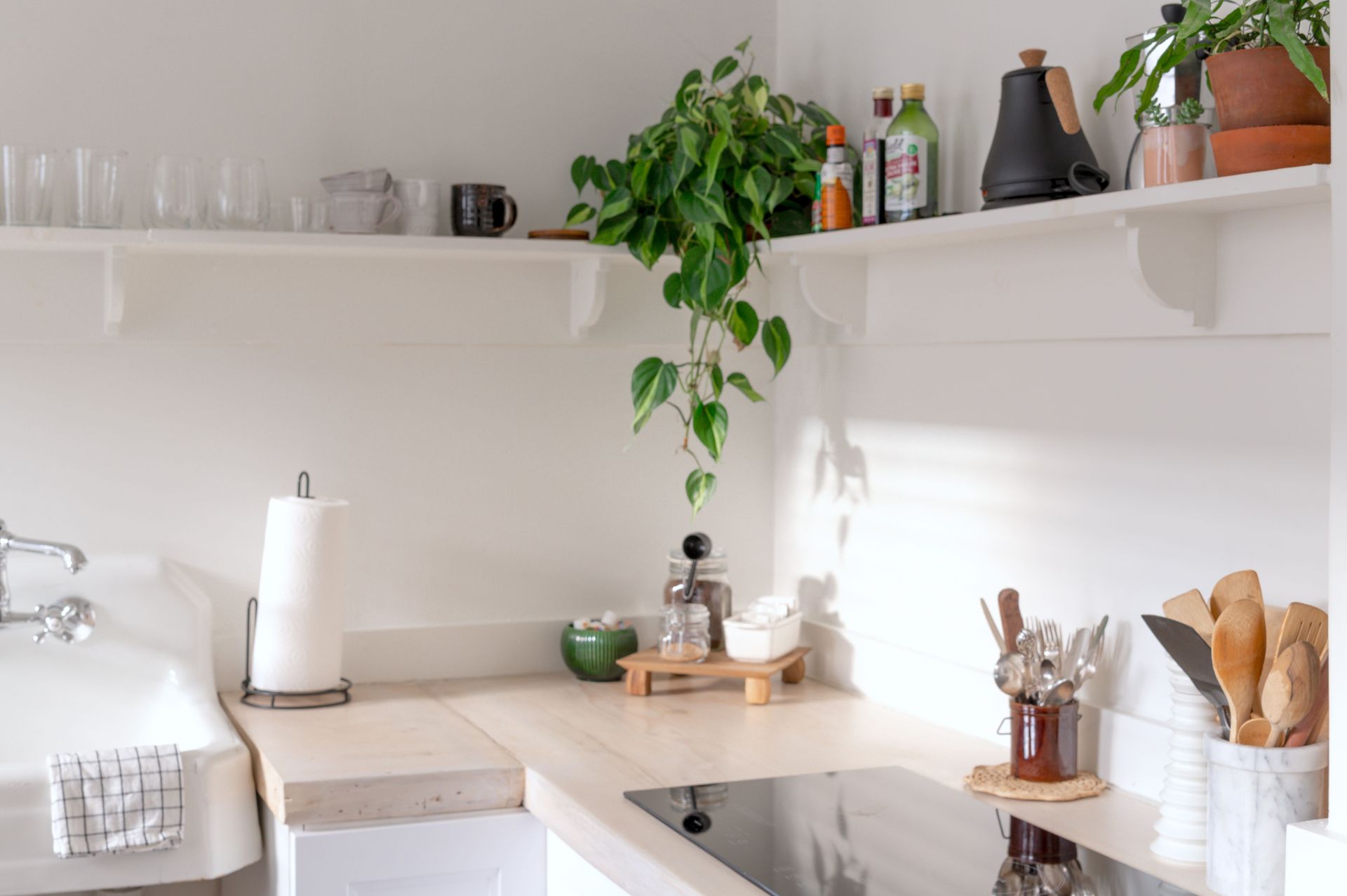 Bright and airy kitchen interior showcasing minimalist design and natural decor elements.